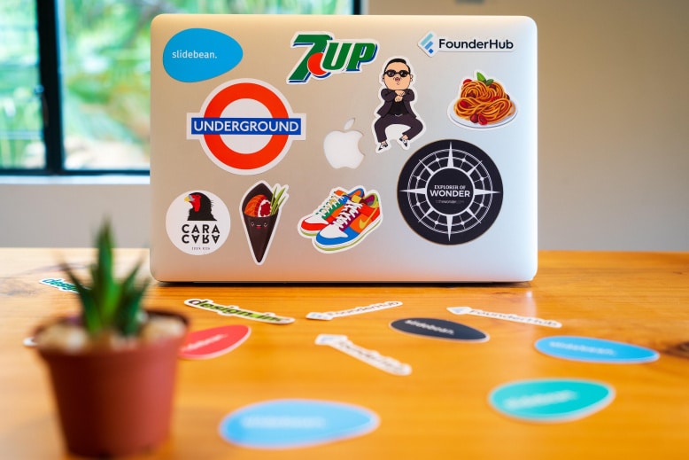 Apple MacBook with stickers used for brand article